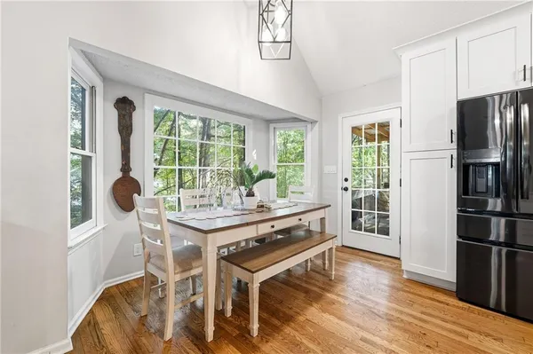 a view of a kitchen with a table and chairs