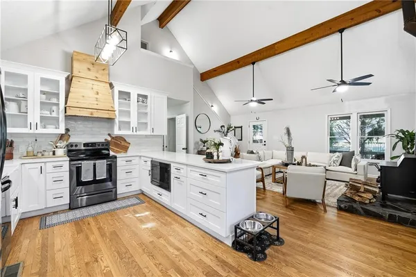 a large white kitchen with cabinets