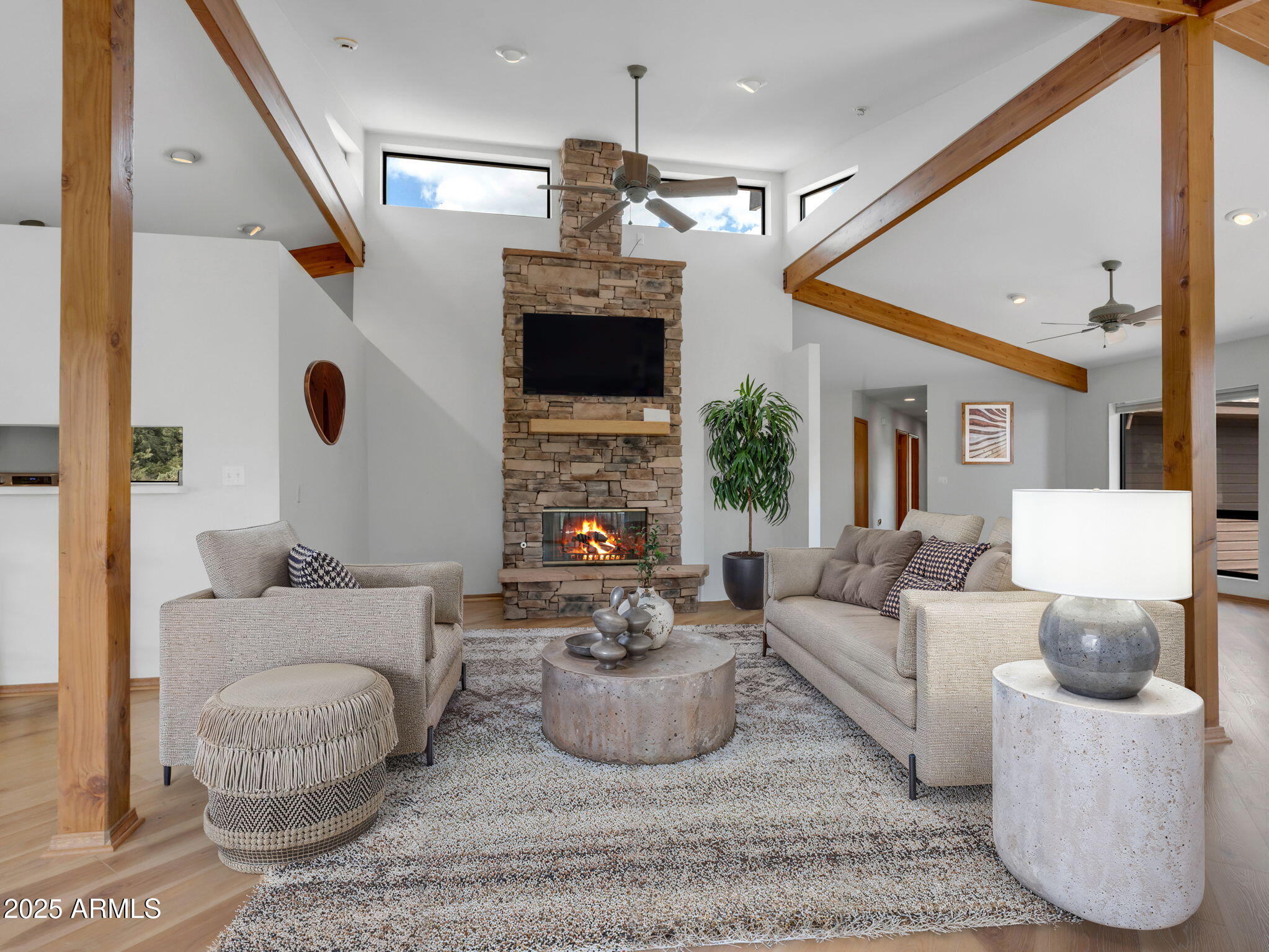 a living room with furniture a fireplace and a flat screen tv