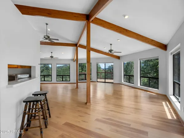 a view of a hallway with wooden floor and a floor to ceiling window