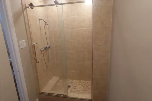 a bathroom with a glass door shower