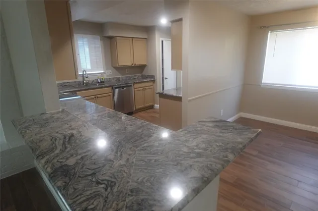 a kitchen with granite countertop a sink and a stove