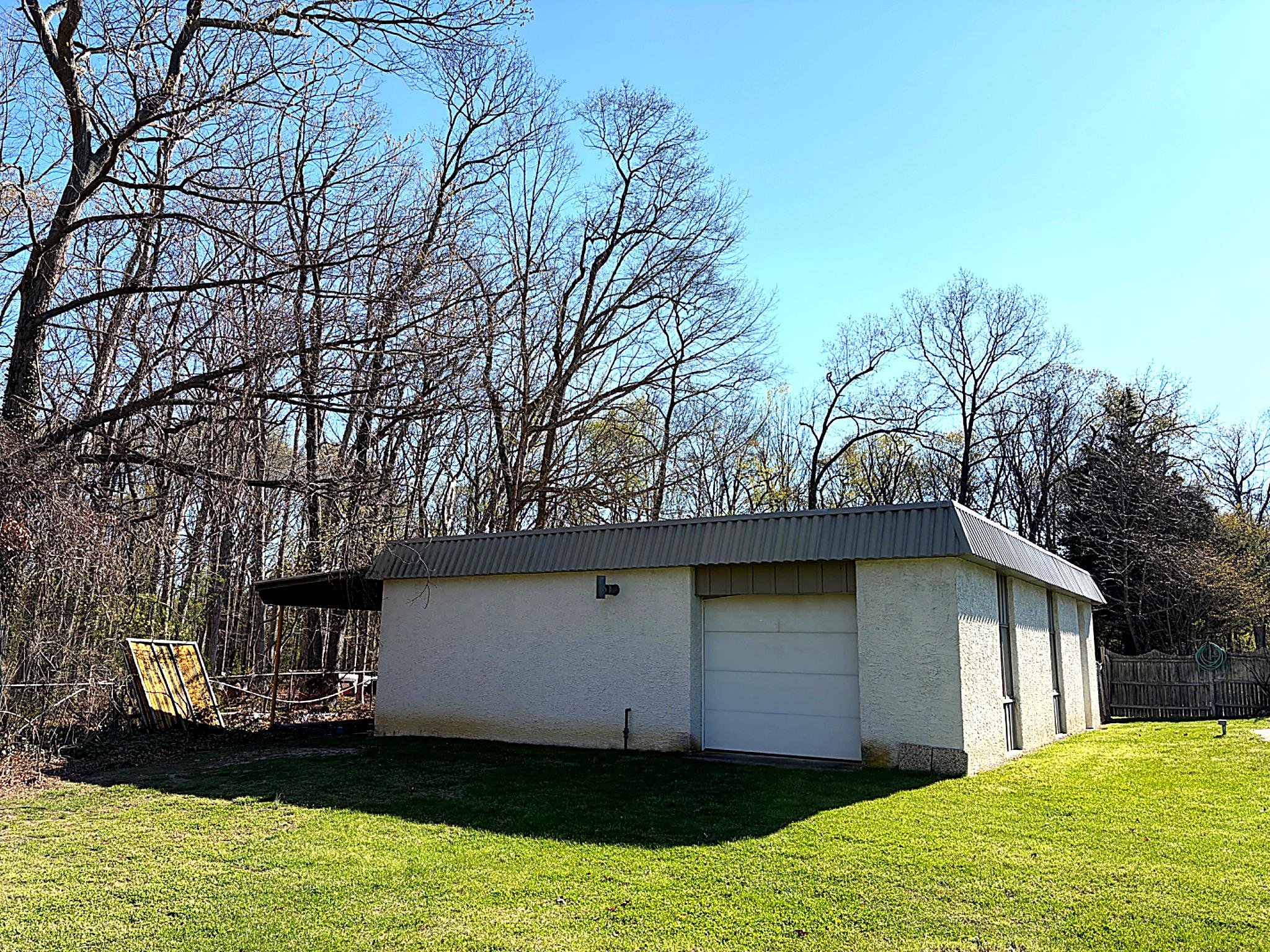 1590 East Elmer Road Vineland, NJ 08361 - Photo 5 of 25 a front view of a house with a garden and yard