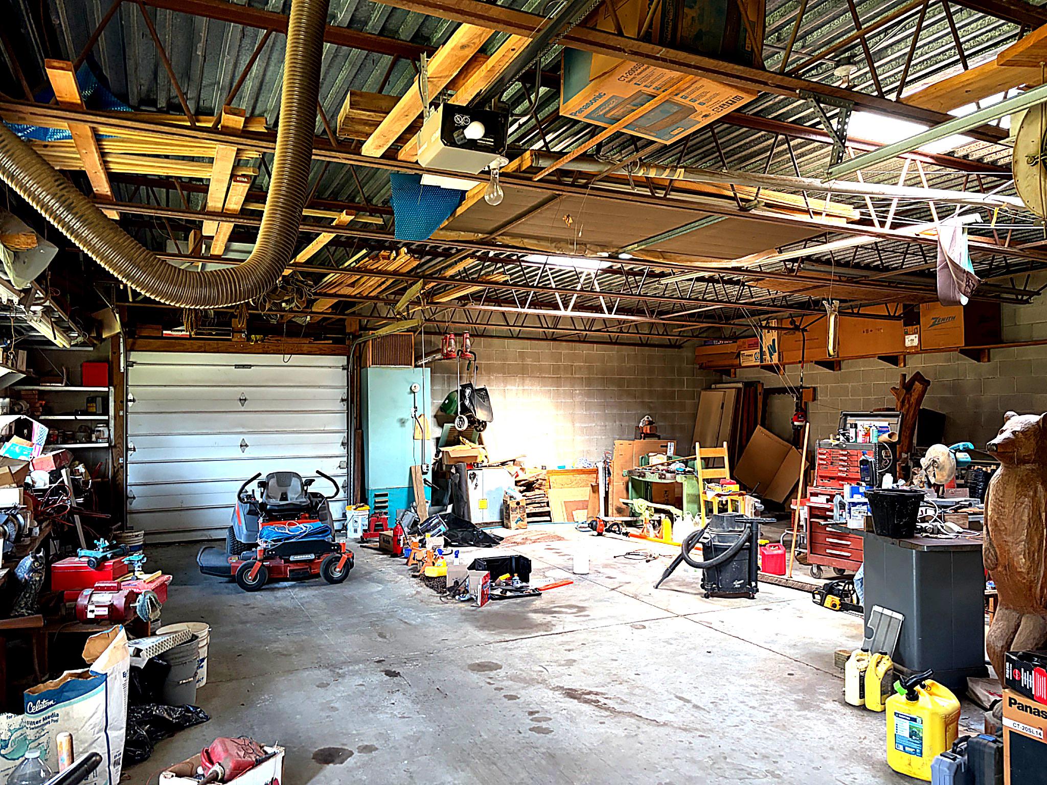 1590 East Elmer Road Vineland, NJ 08361 - Photo 6 of 25 a view of a garage with a bike and car
