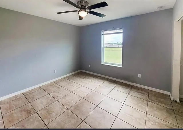 a view of an empty room and a window