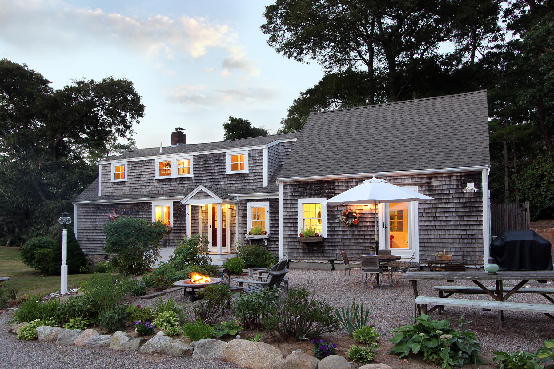 a front view of a house with yard and green space