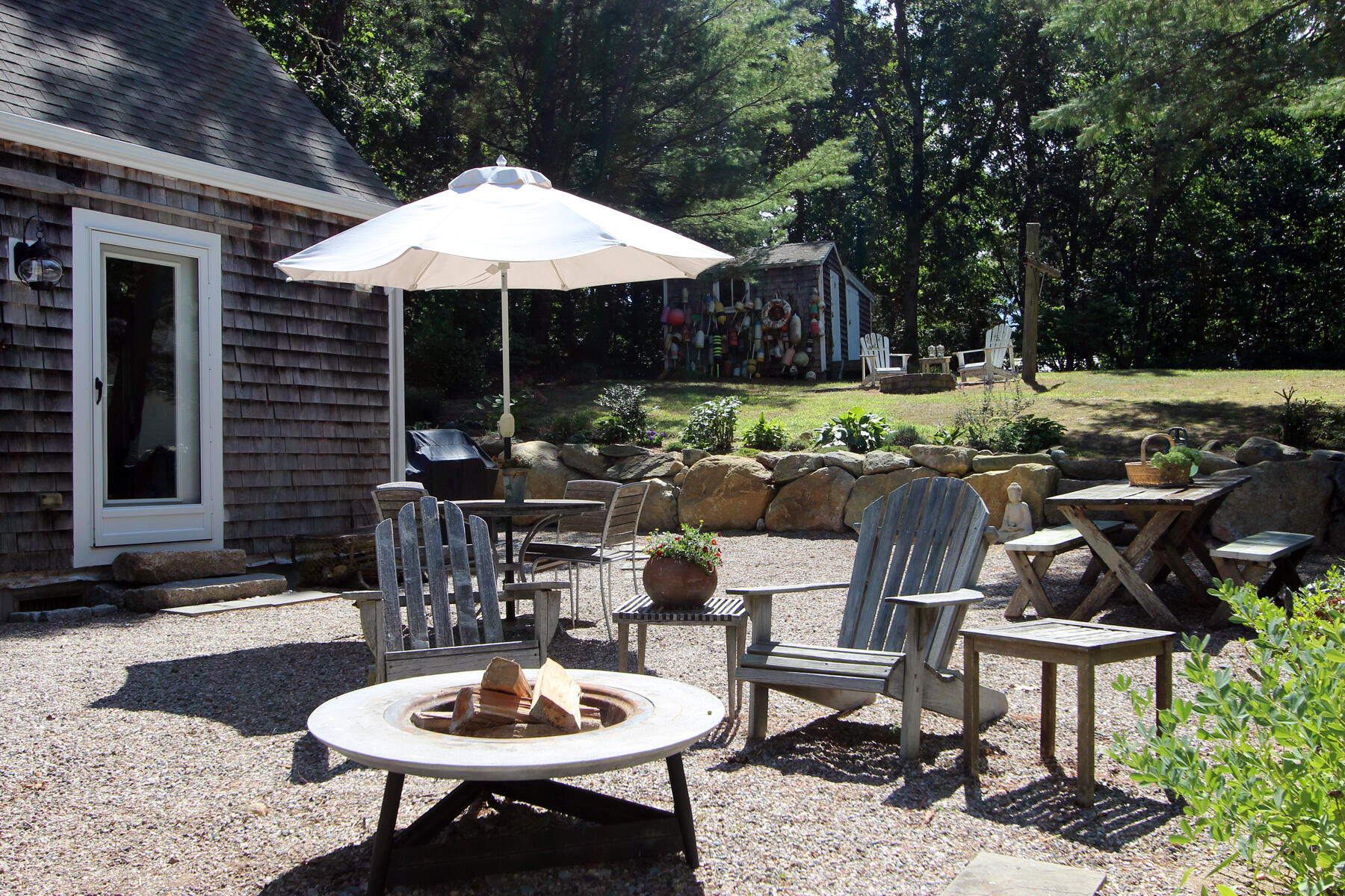 29 Pond Road Orleans, MA 02653 - Photo 28 of 41 a patio with a table and chairs and a umbrella