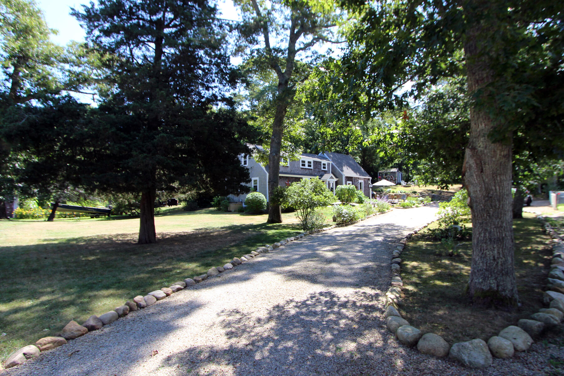 29 Pond Road Orleans, MA 02653 - Photo 29 of 41 a street view with large trees
