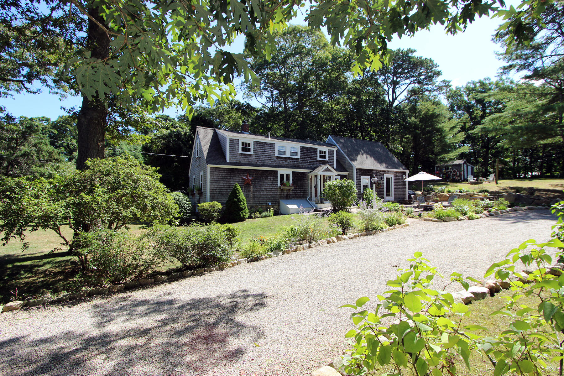 29 Pond Road Orleans, MA 02653 - Photo 30 of 41 a front view of a house with a yard