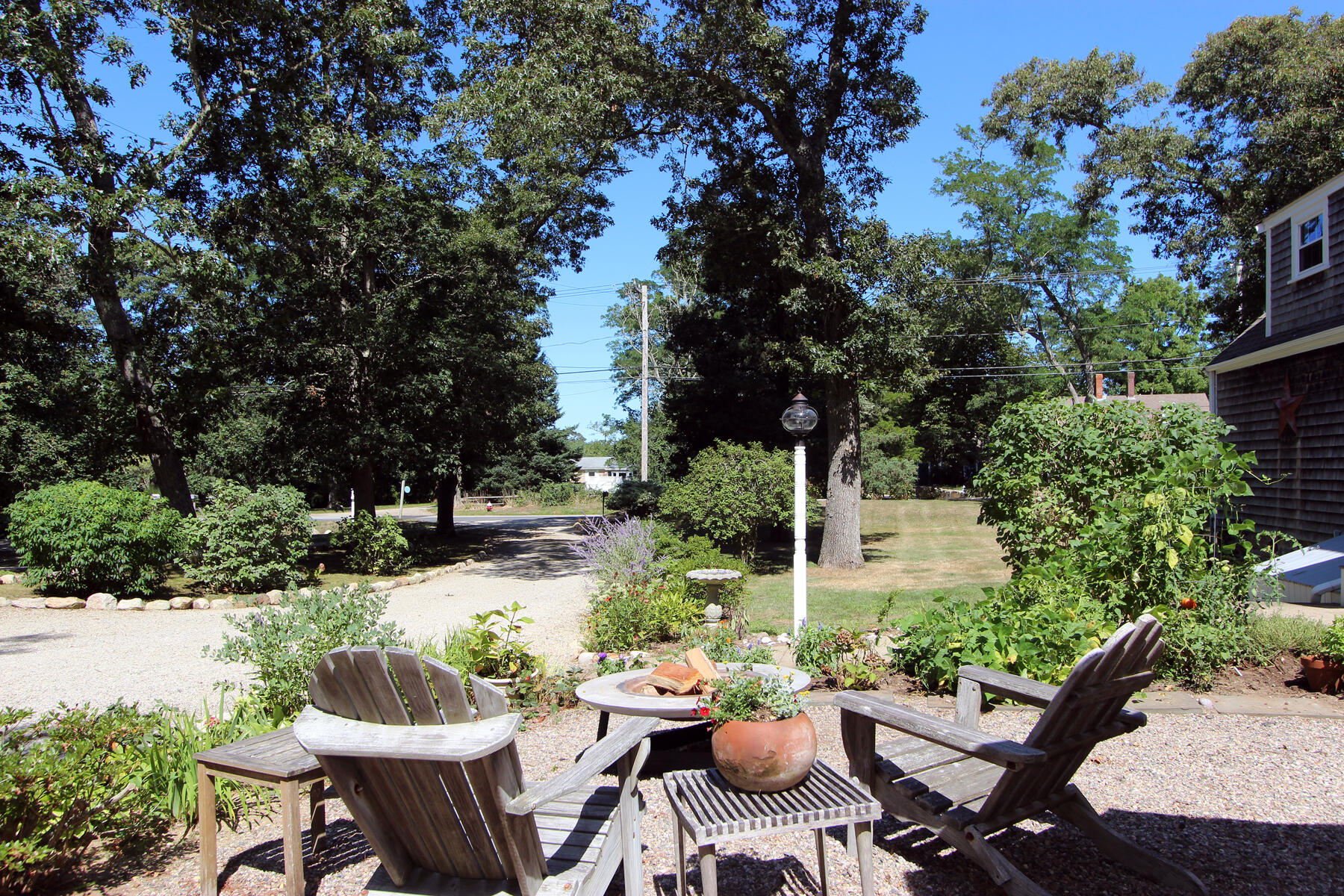 29 Pond Road Orleans, MA 02653 - Photo 33 of 41 a view of a patio with table and chairs and potted plants