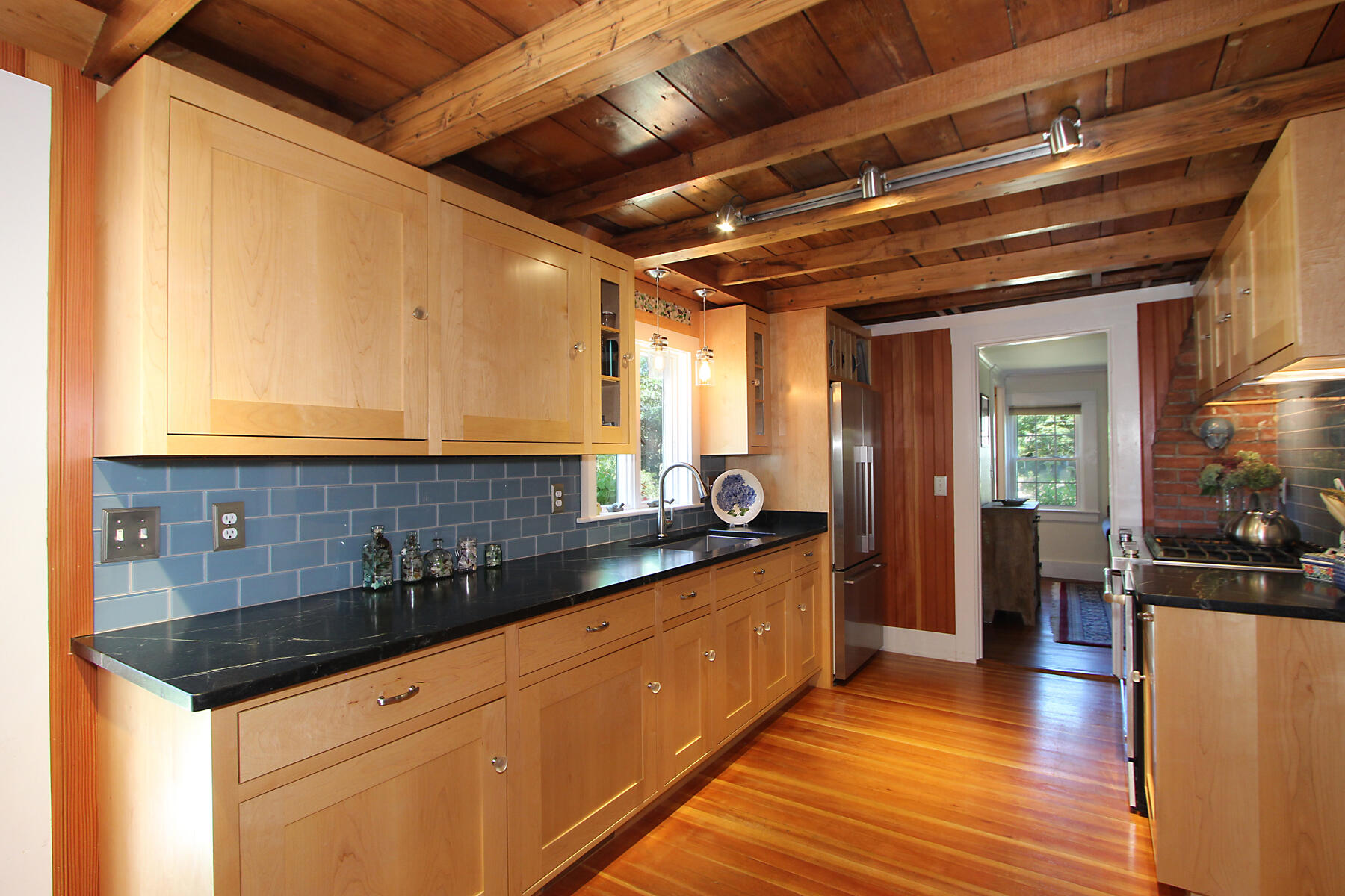 29 Pond Road Orleans, MA 02653 - Photo 6 of 41 a kitchen with granite countertop a sink a counter space and cabinets