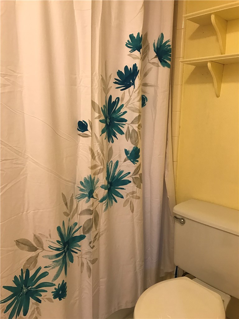 3400 Speedway, Unit 304 Austin, TX 78705 - Photo 11 of 12 a bathroom with a sink a toilet and a mirror