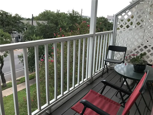 a view of a balcony with chairs