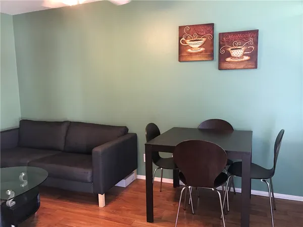 a view of a livingroom with furniture and wooden floor