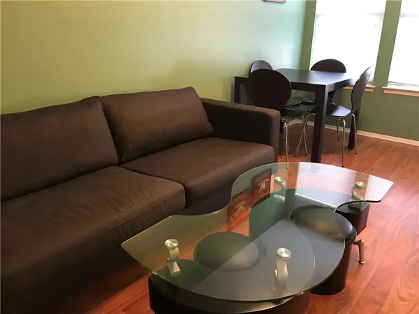 a living room with furniture and a lamp