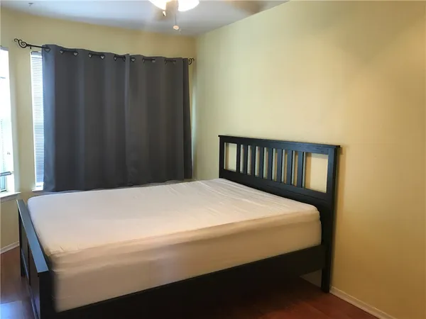 a bed sitting in a bedroom next to a window