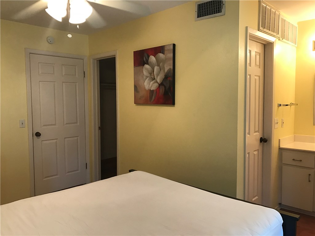 3400 Speedway, Unit 304 Austin, TX 78705 - Photo 9 of 12 a bedroom with a bed and a chandelier