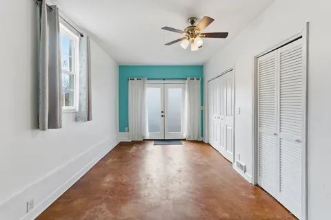 a view of a livingroom with a ceiling fan and window