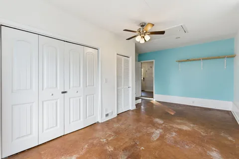 a view of a livingroom with a ceiling fan & window