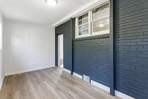 a view of front door with wooden floor
