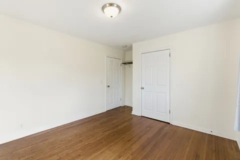 a view of a room with wooden floor