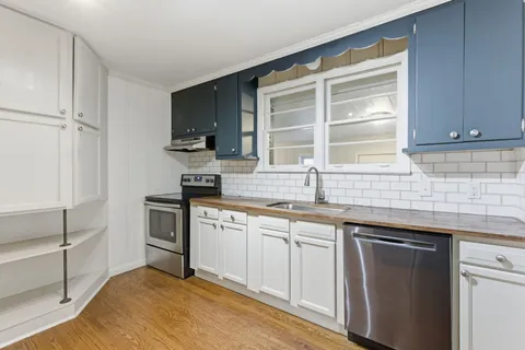 a kitchen with a sink stove and cabinets