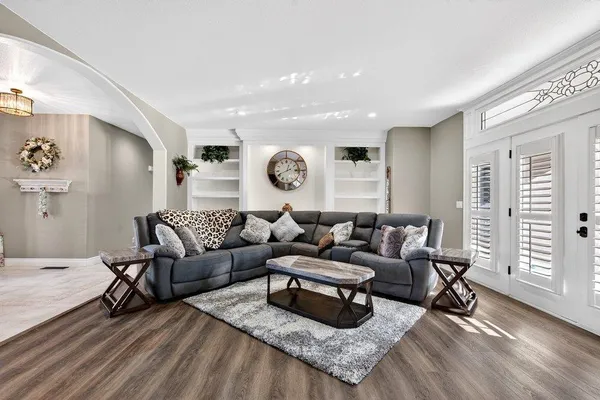 a living room with furniture and wooden floor
