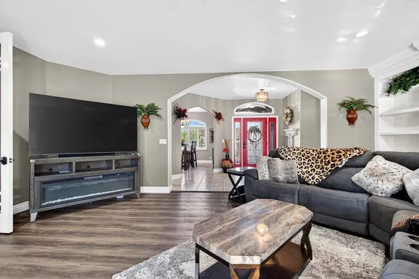a living room with furniture and a flat screen tv