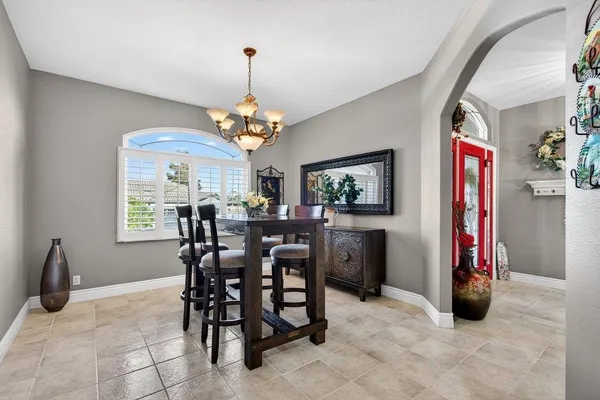 a view of a dining room with furniture and a chandelier
