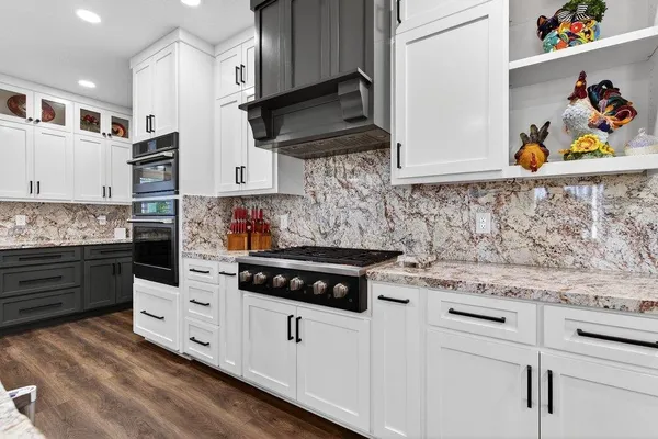 a kitchen with stainless steel appliances white cabinets and a stove