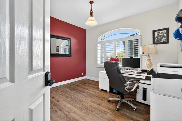 a workspace with furniture window and wooden floor