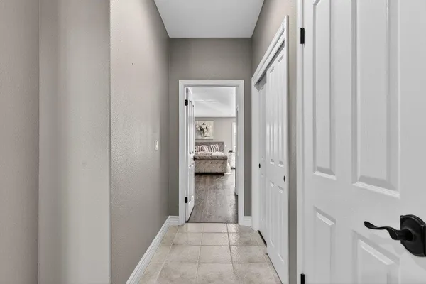 a view of a hallway with wooden floor and closet