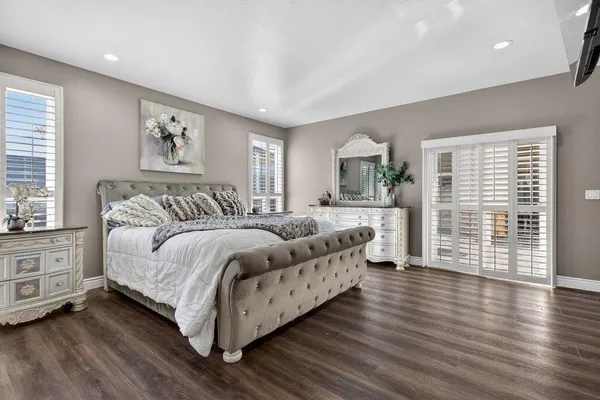 a bedroom with a large bed and a large window