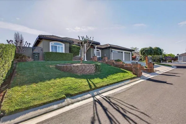 a front view of a house with garden