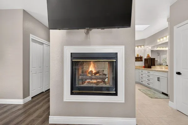 a view of a hallway with a fireplace and cabinet