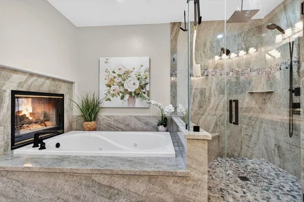 a view of a bathroom with bathtub and shower