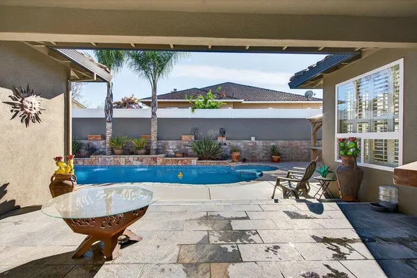 a view of a chairs and table in patio