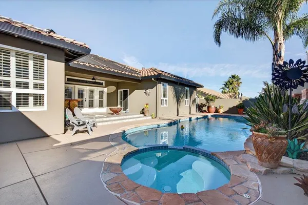 a view of a swimming pool with lounge chair