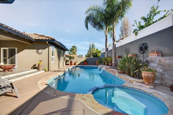 swimming pool view with a seating space