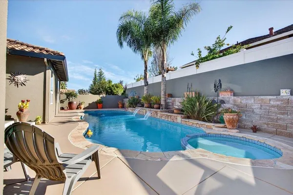 a swimming pool with outdoor seating