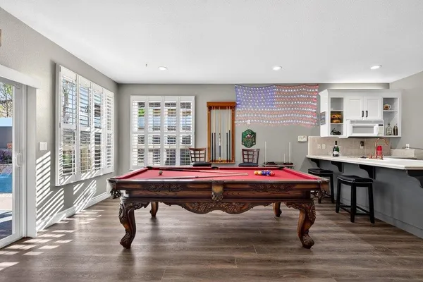 a bathroom with a granite countertop double vanity sink a mirror and a shower
