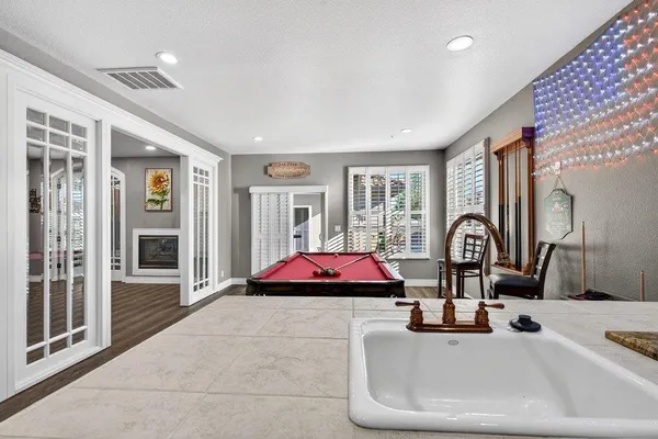 a kitchen with a stove a sink dishwasher and a refrigerator with wooden floor