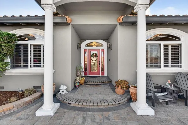 a front view of a house with outdoor seating