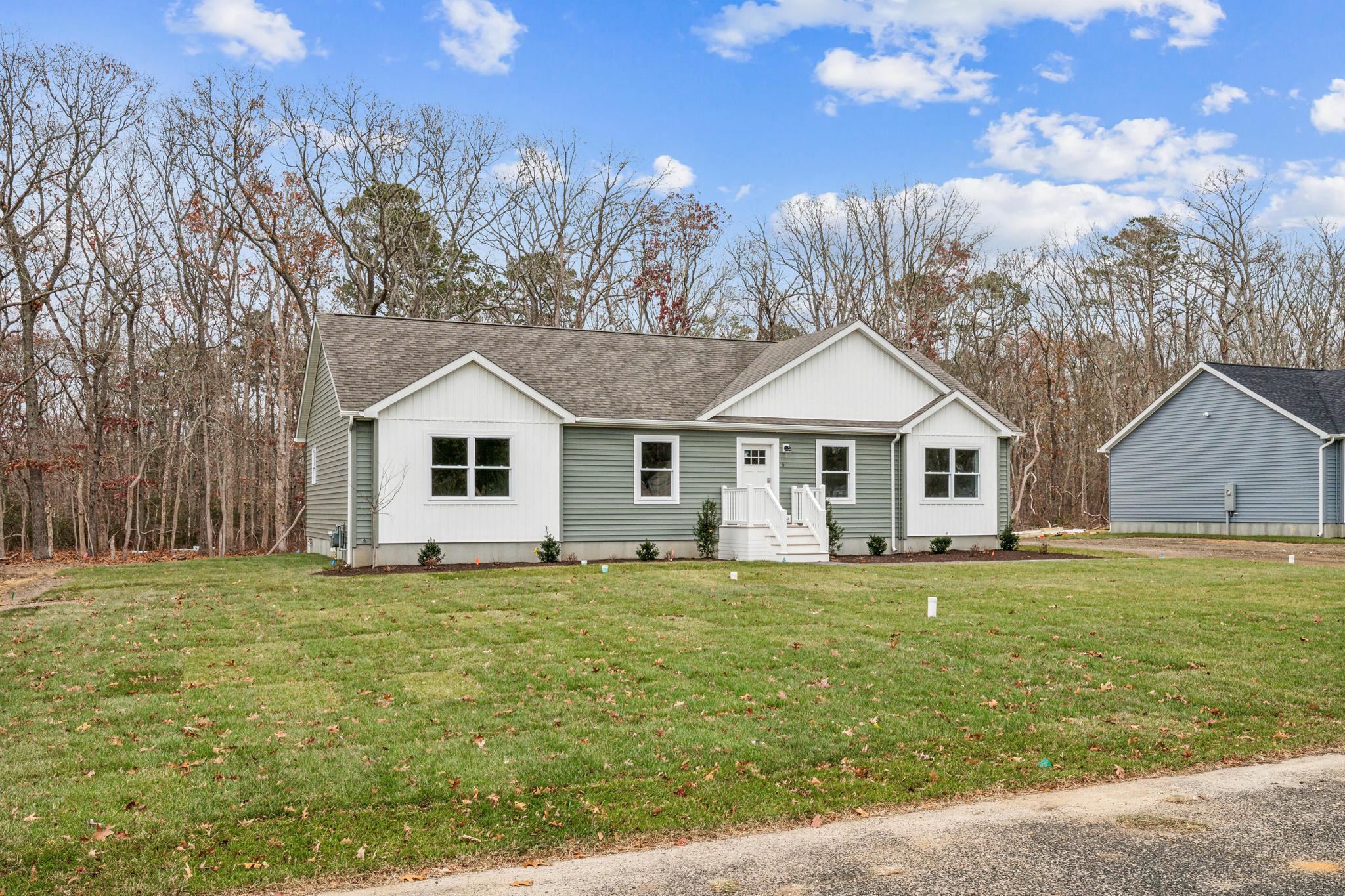76 West Rising Sun Drive Ocean View, NJ 08230 - Photo 3 of 37 a white house with a big yard and large trees