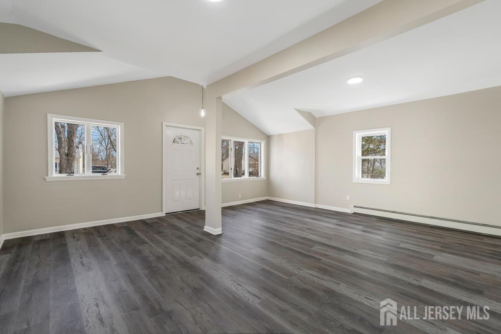 120 Chestnut Street Bridgewater, NJ 08807 - Photo 5 of 32 a view of an empty room with wooden floor and a window