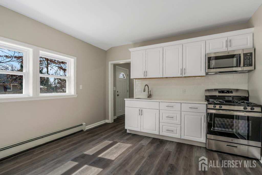 120 Chestnut Street Bridgewater, NJ 08807 - Photo 9 of 32 a kitchen with stainless steel appliances granite countertop a stove a sink and a microwave