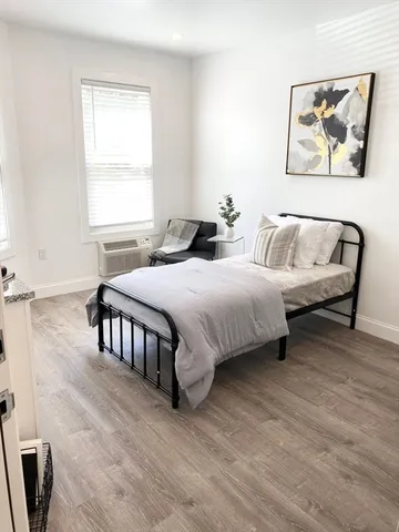 a bedroom with a bed and a cabinet