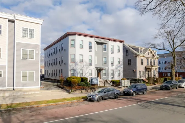 a building outdoor space with a car parked in front of it