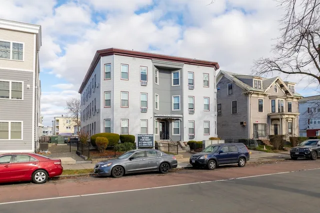 a view of a cars is parked in front of a building