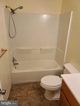 a bathroom with a toilet and shower